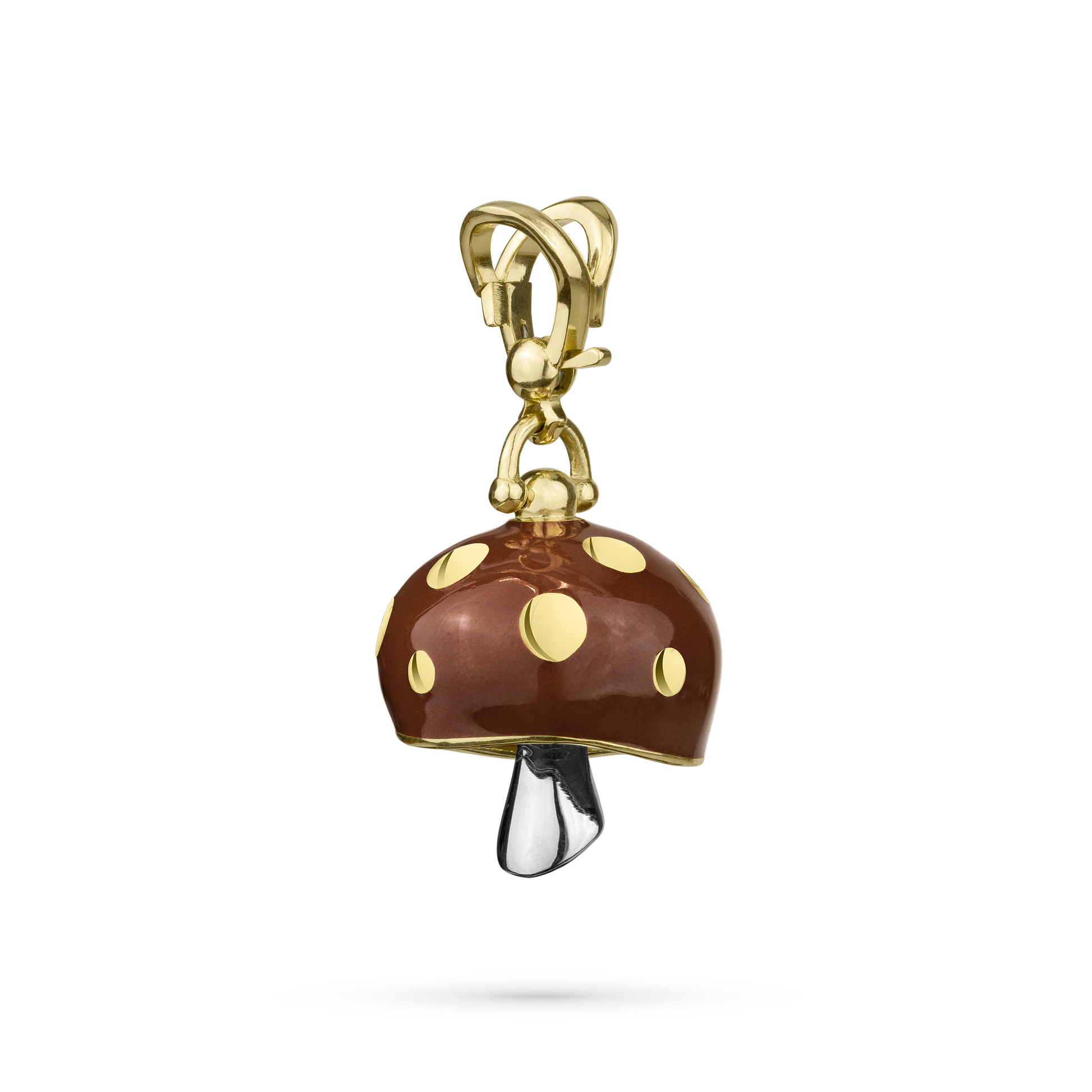 A gold-colored metal meditation bell with a design resembling a stylized mushroom with a white gold clapper.