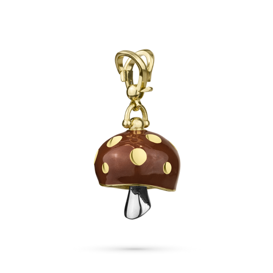 A gold-colored metal meditation bell with a design resembling a stylized mushroom with a white gold clapper.